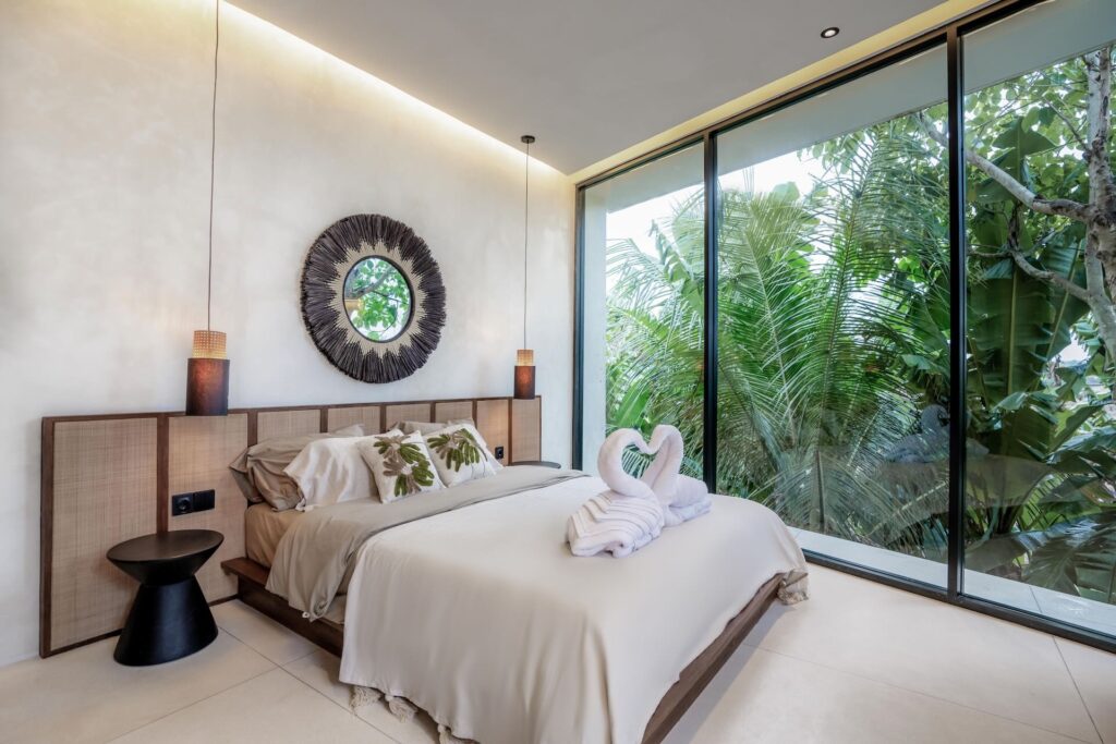 Elegant bedroom at Villa Amore Bereban Bali with garden view