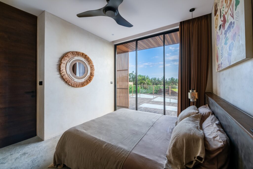 Bedroom interior with balcony access at Villa Amorino Bereban Bali