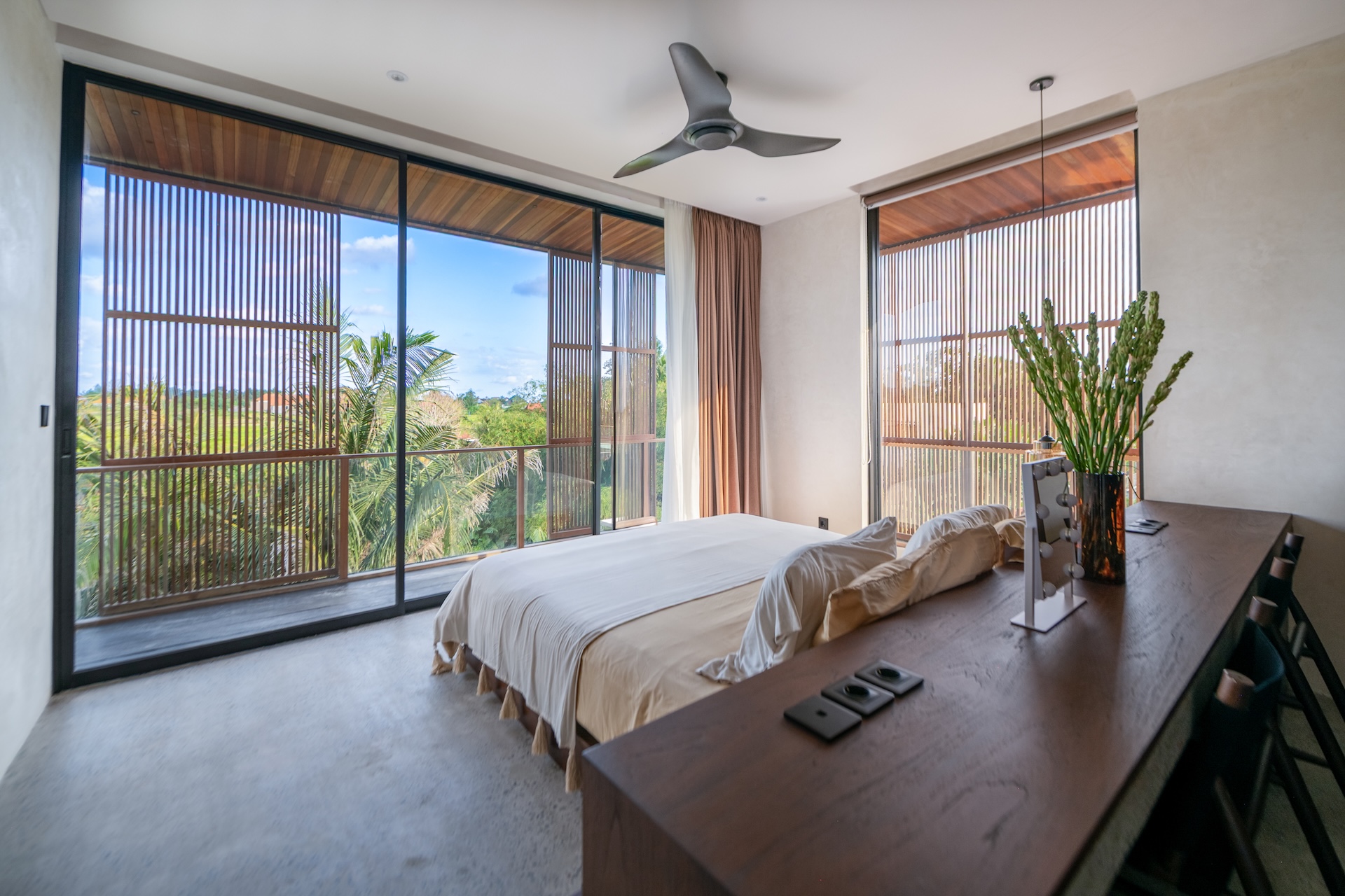Bedroom with large windows overlooking greenery at Villa Amorino Bereban Bali